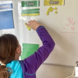 child working on a white board