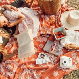 two girls on a blanket reading